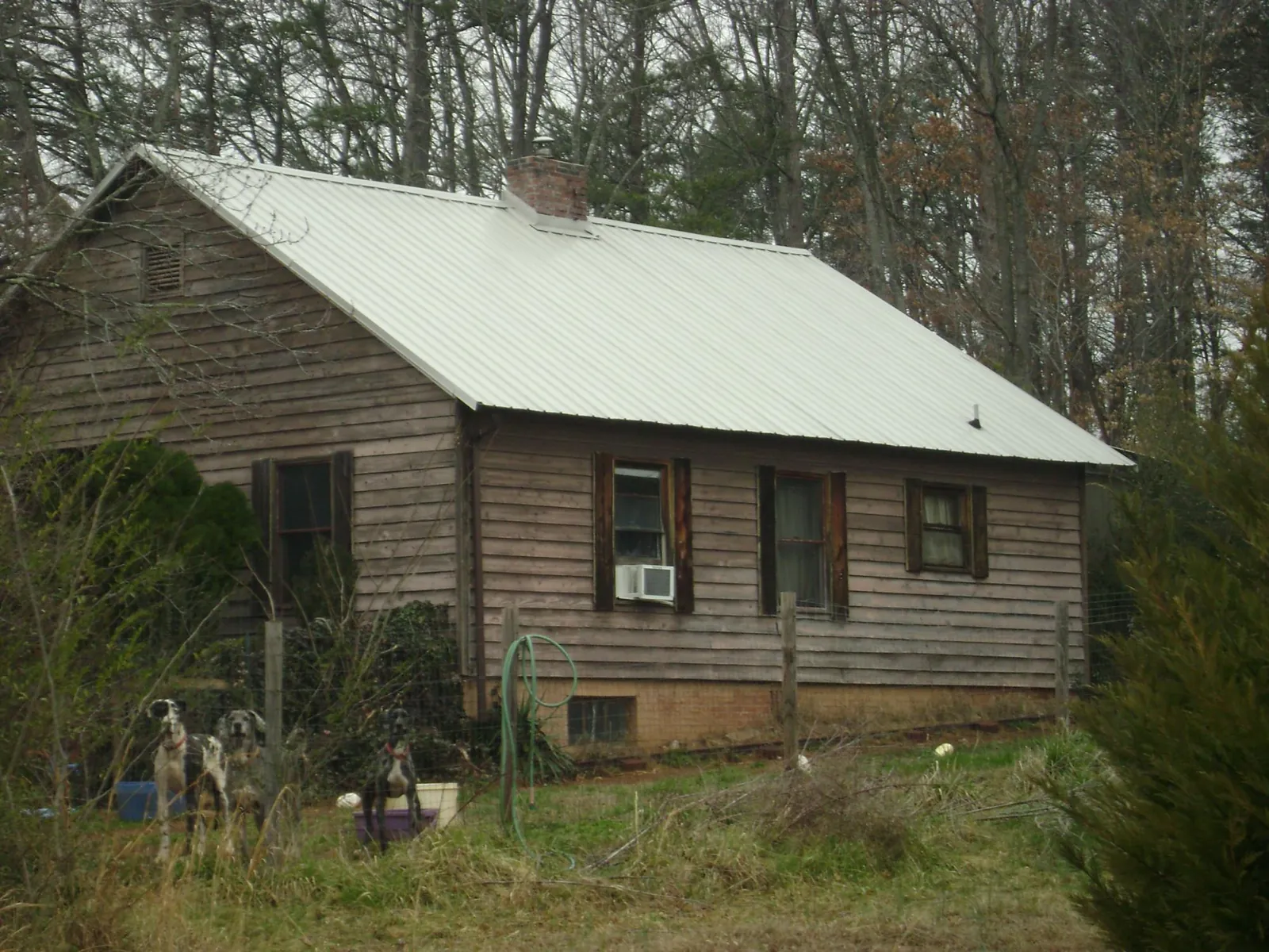 White metal roof on an old wood sided farmhouse, from a Metal Roof Installation job in Newton Center